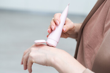 A middle-aged woman applying hand cream