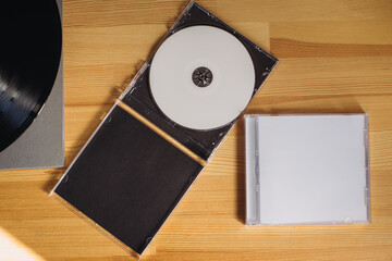 CDs on a wooden table. Mockup.