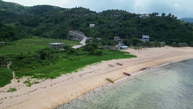 Traditional Outrigger Boats On The Sandy Shore Near Baras In The Province of Catanduanes, Philippines. Aerial Drone Shot