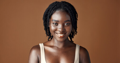 Face, beauty and aesthetic with funny black woman in studio isolated on brown background for...