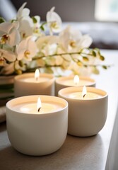 Spa. Four candles on a background of orchid flowers. AI created.
