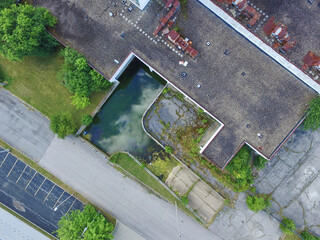 Aerial Top Down View of Neglected Urban Building and Overgrown Lot