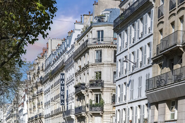 Paris, typical facade, beautiful building in the Marais with an hotel sign
