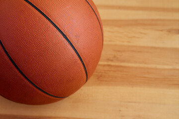 A basketball ball close-up on a wooden floor. Sports background, basketball background
