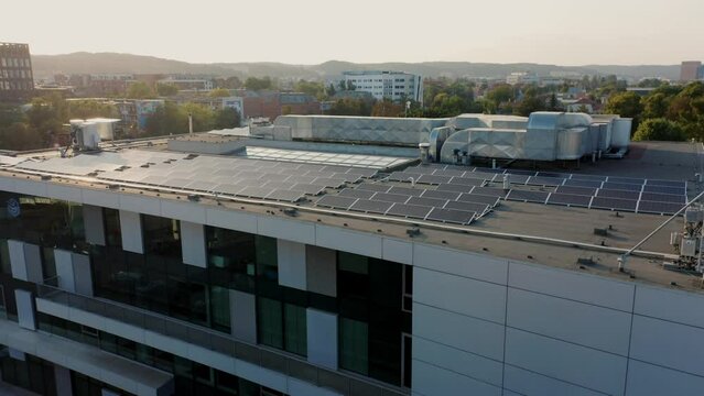 Drone shot solar panels photovoltaic modules installed flat roof office building