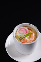 Japanese Traditional food Eggs Custard Chawanmushi isolated in black background