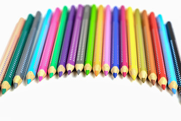 Colored pencils for drawing various colors on a white background.