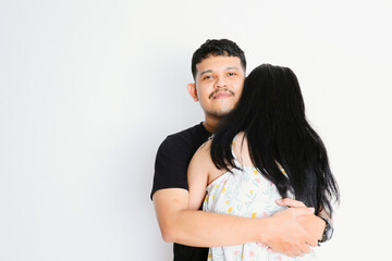 an asian man hugging a woman on a white background, friendship and love concept