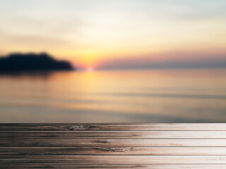 Fototapeta na wymiar Wooden table pattern, blurred sea background in the evening, use for graphic design.