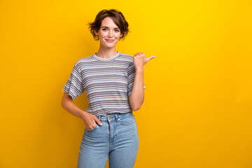 Photo of good mood cheerful woman dressed striped t-shirt indicating at sale empty space arm in...