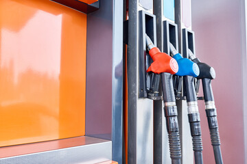 Background image of tech fuel pump with nozzles at petrol station, copy space