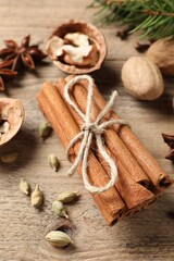 Different spices and nuts on wooden table, above view