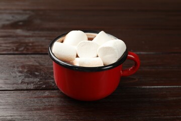 Tasty hot chocolate with marshmallows on wooden table