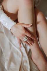 tender hands of a young woman with an expensive ring and a beautiful manicure. Close-up photo of female hands