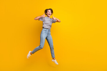 Full body photo of crazy impressed lady jump demonstrate thumb up empty space isolated on yellow color background - obrazy, fototapety, plakaty