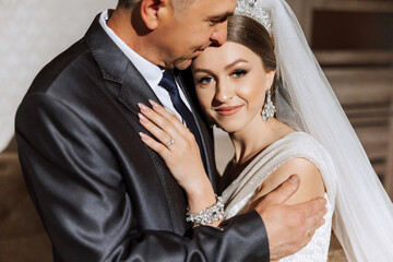 A beautiful bride with her father on her wedding day. The best moments of the wedding day. Daughter and father.