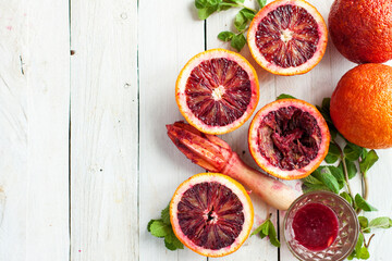 Sliced Blood Oranges with Juicer and Fresh Mint - obrazy, fototapety, plakaty