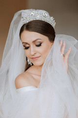 Fototapeta premium Beautiful bride with wedding flowers bouquet, attractive woman in wedding dress. Happy newlywed woman. Bride with wedding makeup and hairstyle. Smiling bride. Wedding day. Gorgeous bride. Marriage.