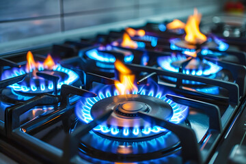 Modern kitchen stove cook with blue flames burning.
