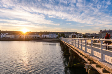 Fototapeta premium Vibrant sunset casting golden light over Beaumaris Pier in North Wales - United Kingdom