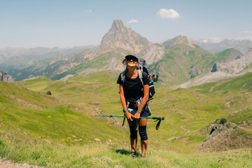 hiker and view of Pic d'Ossau in the French Pyrenees National Park. Ossau Valley, Pyrenees National Park, Pyrenees, France.