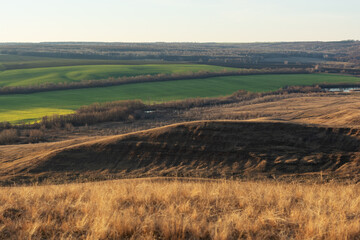 Panoramic view of the rural landscape from a hill at sunset or dawn.
