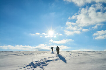 Unrecognizable explorer hiking on mountain trail in winter overcoming obstacles and braving difficulties