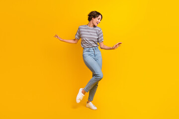 Fototapeta na wymiar Full length photo of cheerful positive girl dressed nice clothes celebrate summer sales isolated on yellow color background