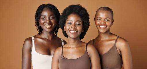 Face, beauty and wellness with black woman friends in studio on a brown background for natural...