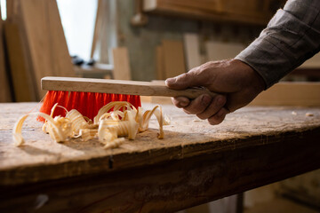 Carpenter's work. Wood shavings, chip. Sweep wood shavings from the work surface