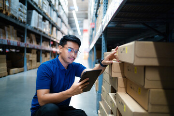 Asian warehouse worker uses tablet computer looking at merchandise. Logistics and export business Logistics distribution center.