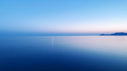 Aerial view of the calm sea with the rays of the rising sun