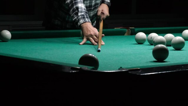 Cue in man's hand hits the white ball and it doesn't hit the pocket. Bad shot in billiard. Playing in Russian billiards