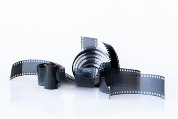 Different pieces and rest of 35 mm photography film, analog or chemical photography, on a white background. 35mm Red Negative Photo Film Stripes Frame Gritty Scan Pieces.