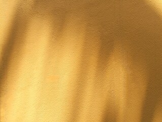 In the picture, there is an orange wall with light shining on the wall in various shapes. It looks like an art of light and shadow. It has a soft orange color, the light of the morning sun one day.