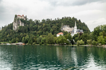 Lake Bled Slovenia. Beautiful mountain lake with small Pilgrimage Church. Most famous Slovenian lake and island Bled with Pilgrimage Church of the Assumption of Maria and Bled Castle in background.