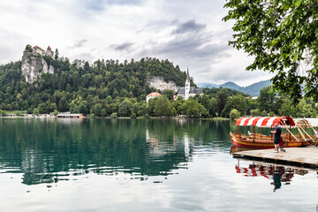 Lake Bled Slovenia. Beautiful mountain lake with small Pilgrimage Church. Most famous Slovenian lake and island Bled with Pilgrimage Church of the Assumption of Maria and Bled Castle in background.