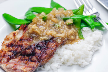 pork steak with onion sauce, green beans and rice