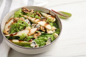 Delicious pear salad with sauce in bowl on light table, closeup. Space for text