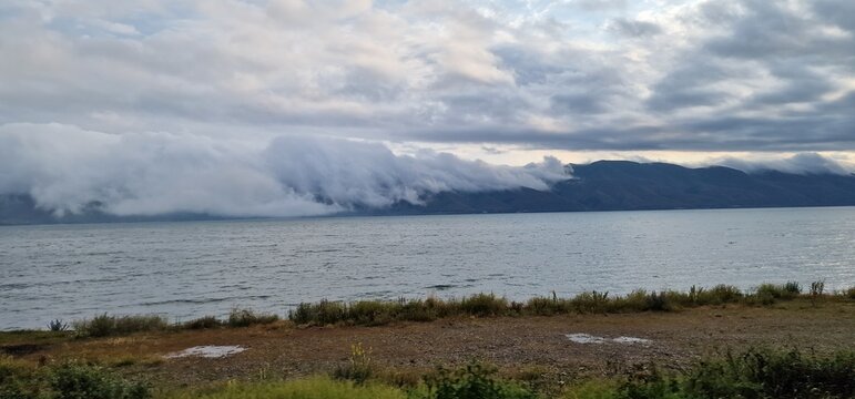 lake sevan in armenia and clouds falling over the mountains