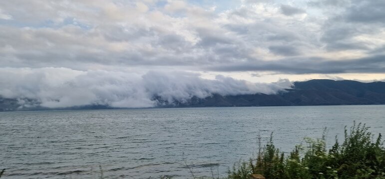 lake sevan in armenia and clouds falling over the mountains