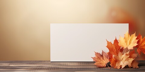 Naklejka na ściany i meble Minimal autumn concept with creative autumn composition featuring a screen banner, displayed on an empty wooden kitchen table with maple leaves.