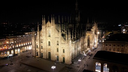 Fototapeta na wymiar EUROPE, ITALY, MILAN 01-24-2024 Milan Cathedral Piazza Duomo by night drone aerial view - sightseeing and tourist attraction in downtown of the fashion city - new skyline 