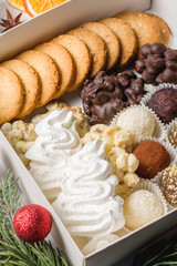 Assorted candies and cookies in a box. Christmas atmosphere. Top view