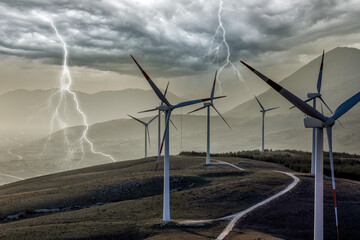 A wind farm or wind park at sunset located in the mountains of Italy Europe and it allows to...