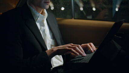 Closeup businessman hands typing computer keyboard in car. Nervous man working - obrazy, fototapety, plakaty