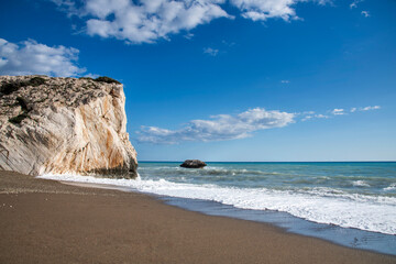 Aphrodite Beach with Stone Rocks in Aphrodite bay of Mediterranean sea water, Petra tu Romiou,...