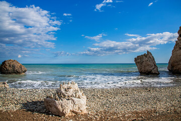 Fototapeta na wymiar Aphrodite Beach with Stone Rocks in Aphrodite bay of Mediterranean sea water, Petra tu Romiou, Cyprus (1)