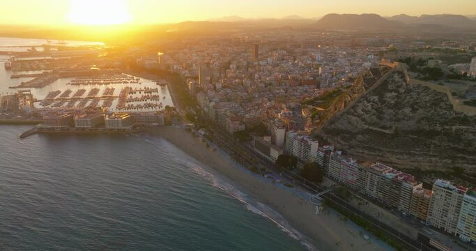 Sunset over the city center and marina of Alicante city, medieval fortess of Santa Barbara. Spain, Costa blanca