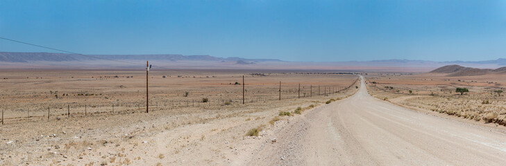 C13 gravel road and colorful flatland in Naukluft desert, north of Aus,  Namibia